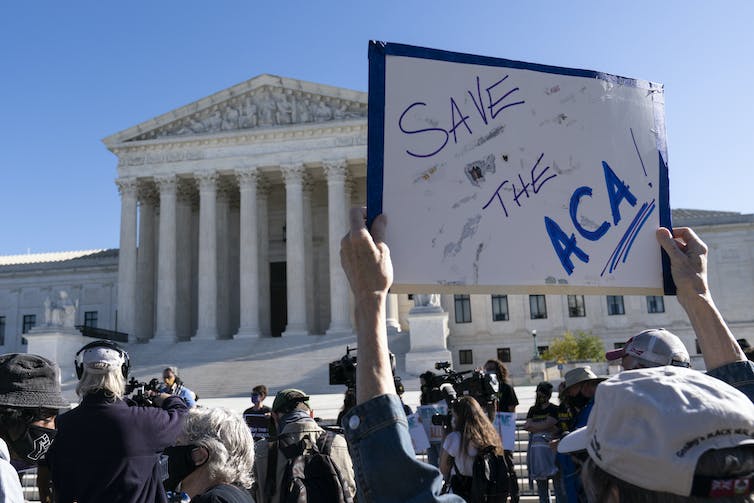 The Demonstrator Holds A Sign Saying 'Save The Aca' In Front Of The United States Supreme Court.