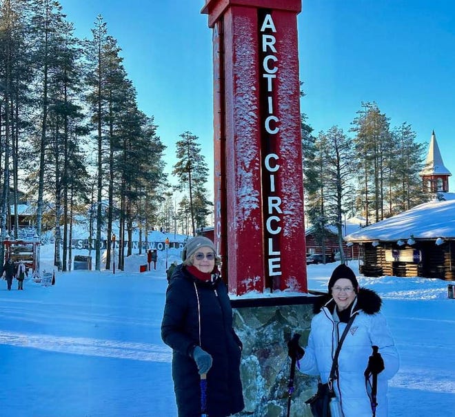 Best Friends Ellie Hamby And Sandy Hazelip Huddle Around The Arctic Circle In Lapland, Finland In February.