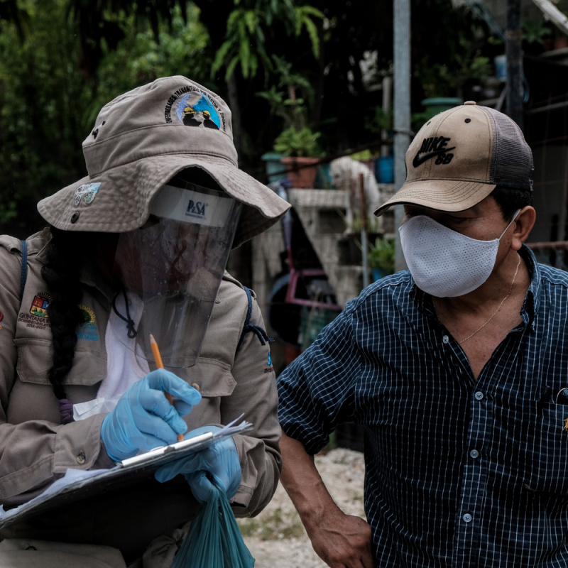 Guy Spraying His Arm With Insect Repellent