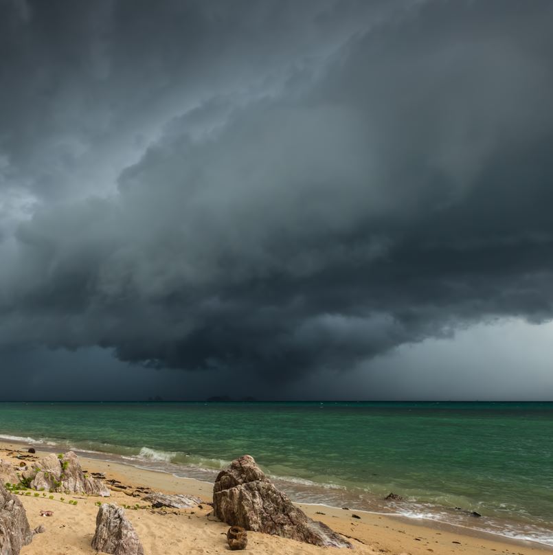 Dark Storm Clouds Over The Beach And Ocean