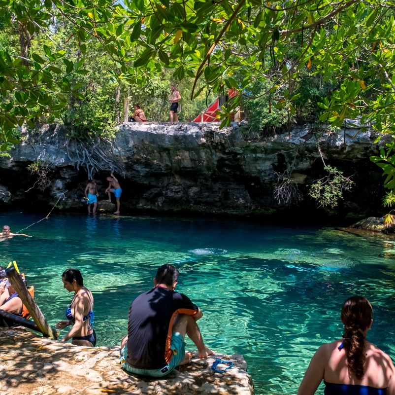 Travelers Enjoying A Cenote In Mexico