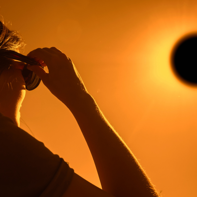 Woman Watching A Solar Eclipse