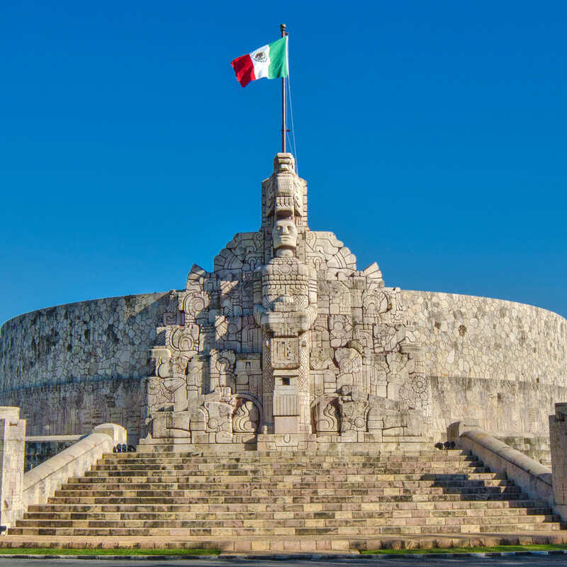 Mexican Flag Waving Atop A Historic Fort In Merida, Yucatan, Mexico